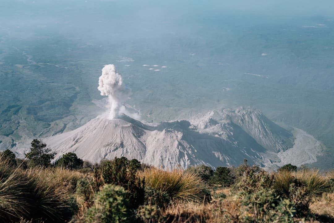 Volcano erupting with smoke billowing into the sky